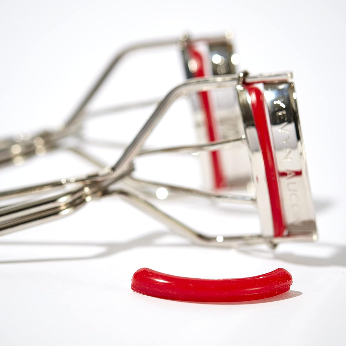 The Eyelash Curler: Easy use. Long-lasting curl of lashes effect. Wide opening. Stainless steel with two red lash